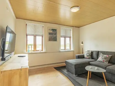a living room with a couch and a tv at 10 person holiday home in Vestervig-By Traum in Vestervig