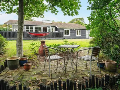 a table and chairs in front of a house at 6 person holiday home in Struer-By Traum in Struer