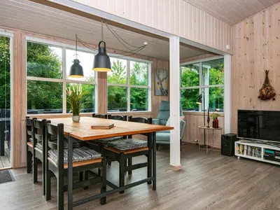 a dining room with a wooden table and chairs at 6 person holiday home in Struer-By Traum in Struer