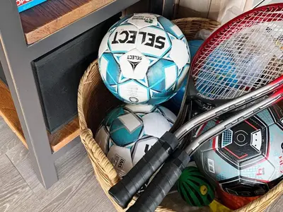 a basket filled with soccer balls and tennis rackets at 6 person holiday home in Struer-By Traum in Struer