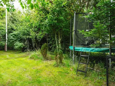 a tree house with a ladder in a yard at 6 person holiday home in Struer-By Traum in Struer