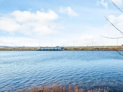a large body of water with a bridge in the background at 6 person holiday home in Højslev-By Traum in Højslev