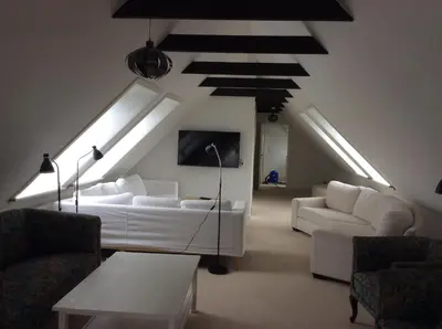 a living room with a white couch and some lights at Lundø in Højslev