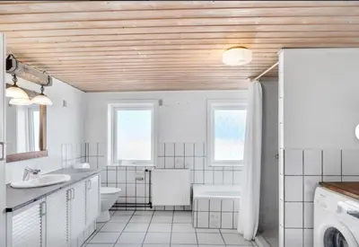 a white bathroom with a sink and a toilet at Lundø in Højslev
