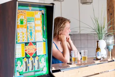 a woman sitting at a bar looking at a computer screen at Stone Mountain BnB in Stenbjerg