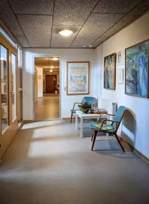 a hallway with a table and chairs in a room at Skærum Mølle in Vemb