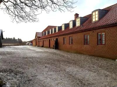 a brick building with a lot of windows on it at Skærum Mølle in Vemb