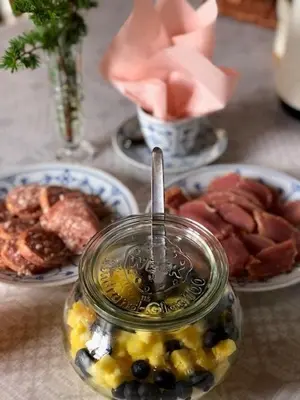 a jar of food on a table with plates of food at Skærum Mølle in Vemb