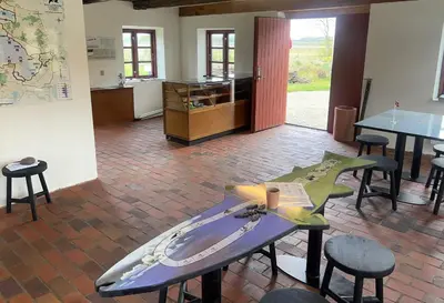 a room with a table with a surfboard on it at Skærum Mølle in Vemb