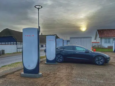 a car is parked next to two electric meters at 4 person apartment in holiday park Blokhus in Blokhus