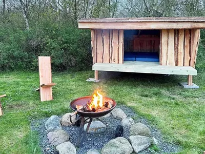 a fire pit in front of a dog house at 8 person holiday home in Struer-By Traum in Struer