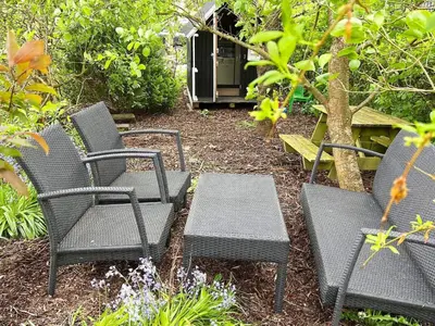 a group of chairs and a table in a garden at 8 person holiday home in Struer-By Traum in Struer