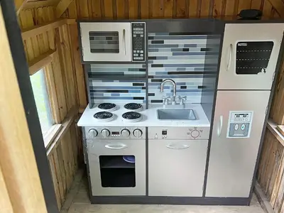 a small kitchen with a stove and a microwave at 8 person holiday home in Struer-By Traum in Struer