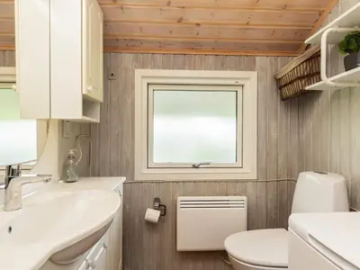 a bathroom with a toilet and a sink and a window at 8 person holiday home in Højslev-By Traum in Højslev
