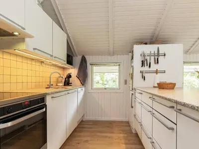 a kitchen with white cabinets and a counter top at 8 person holiday home in Højslev-By Traum in Højslev