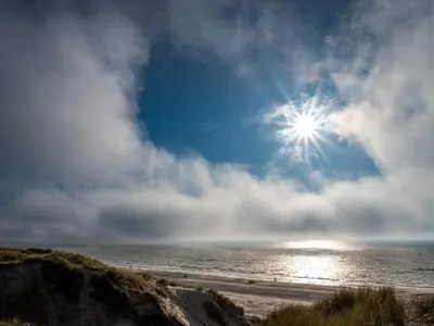 a view of a beach with the sun in the sky at 6 person holiday home in Løkken-By Traum in Løkken