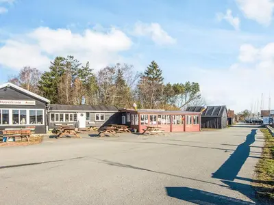 a street with a building with a picnic table at 20 person holiday home in Højslev-By Traum in Højslev