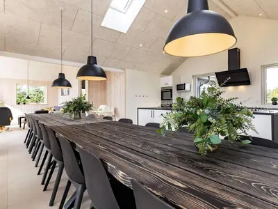 a long wooden table with chairs and pendant lights at 20 person holiday home in Højslev-By Traum in Højslev