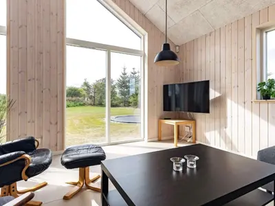a living room with a table and a large window at 20 person holiday home in Højslev-By Traum in Højslev
