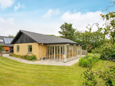 a yellow house with a black roof at 8 person holiday home in Struer-By Traum in Struer