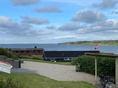 a building with a view of a body of water at Ældre Sommerhus Max 4 voksne og 4 børn in Lemvig