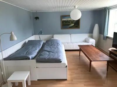 a living room with a white couch and a table at Sommerhus på Mors in Øster Assels