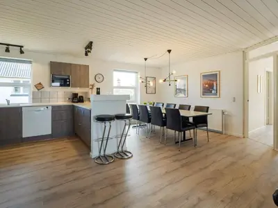 a kitchen and dining room with a table and chairs at Renovated Retreat with Pool - By Traum Ferienwohnungen in Thisted