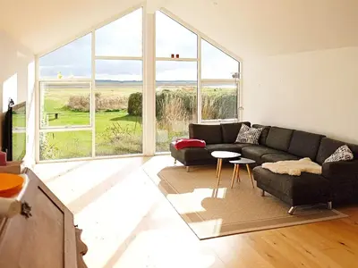 a living room with a couch and a large window at 8 person holiday home in Vesløs-By Traum in Vesløs
