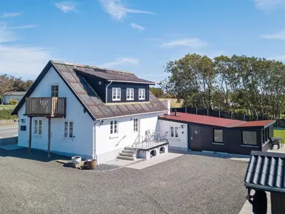 a white house with a red roof and a garage at 10 person holiday home in Roslev-By Traum in Roslev
