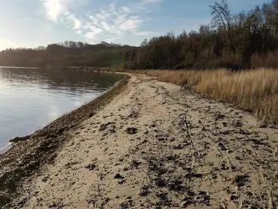 a dirt road next to a body of water at 10 person holiday home in Roslev-By Traum in Roslev