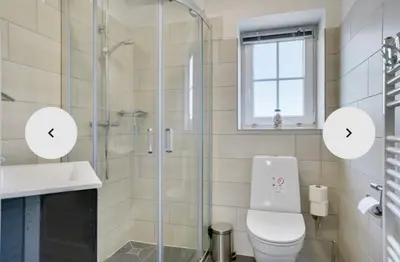 a bathroom with a shower and a toilet and a sink at Cold Hawaii in Torsted