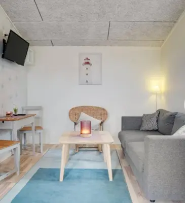 a living room with a couch and a table at Cold Hawaii in Torsted
