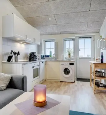 a kitchen and living room with a couch and a table at Cold Hawaii in Torsted