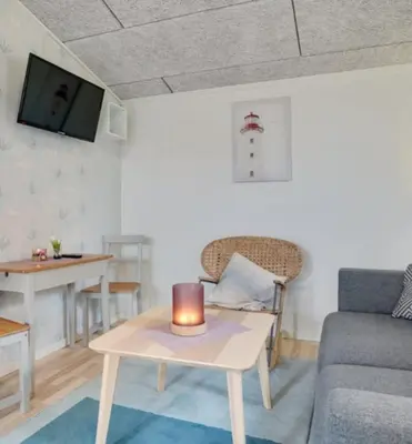 a living room with a couch and a table with a candle at Cold Hawaii in Torsted