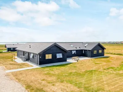 a black house with a large yard at Luxury Retreat with Pool - By Traum Ferienwohnungen in Harboør