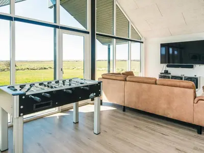 a living room with a table and a couch at Luxury Retreat with Pool - By Traum Ferienwohnungen in Harboør