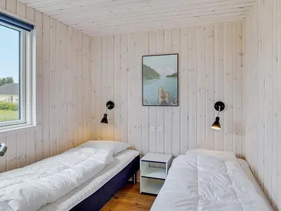 a bedroom with two beds and a window at Luxury Retreat by Limfjorden - By Traum Ferienwohnungen in Spottrup