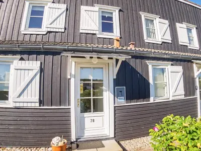 a wooden house with a white door at 6 person holiday home in Vestervig-By Traum in Vestervig