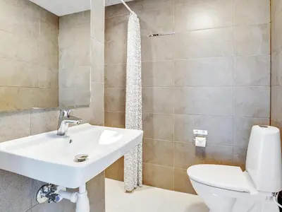 a bathroom with a sink and a toilet at Luxury Retreat for 18 - By Traum Ferienwohnungen in Spottrup
