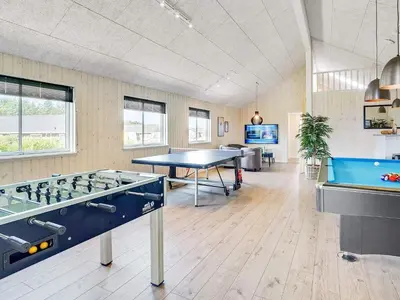 a room with a ping pong table and a pool table at Luxury Retreat for 18 - By Traum Ferienwohnungen in Spottrup