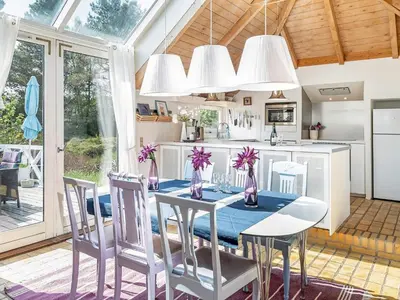 a kitchen with a dining room table and chairs at 10 person holiday home in Fjerritslev-By Traum in Fjerritslev