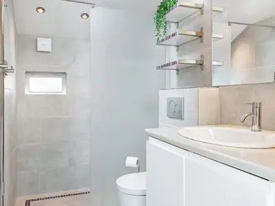 a white bathroom with a sink and a toilet at 10 person holiday home in Fjerritslev-By Traum in Fjerritslev