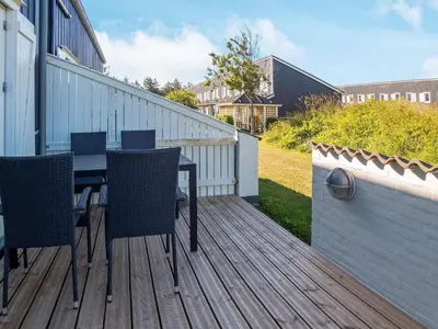a wooden deck with a table and chairs on it at 6 person holiday home in Vestervig-By Traum in Vestervig