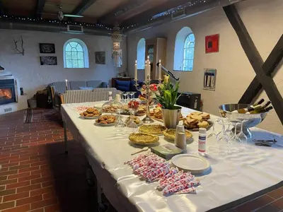 a long table with food on it in a room at Glædegården -Glaede Landhof- 12 beds! in Frøstrup