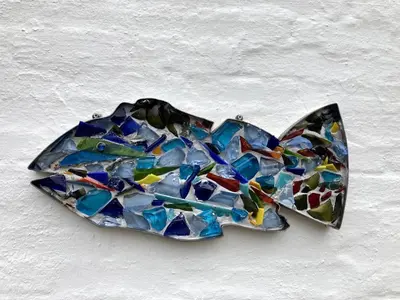 a butterfly made out of stained glass on a wall at Glædegården -Glaede Landhof- 12 beds! in Frøstrup
