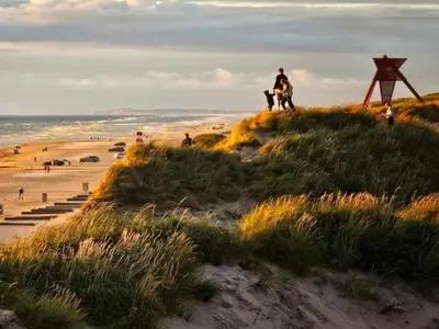 a group of people standing on a beach at 8 person holiday home in Blokhus-By Traum in Blokhus