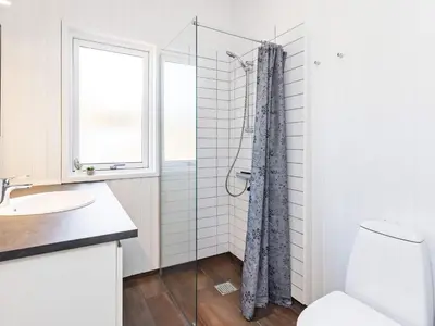 a bathroom with a shower and a toilet and a window at 10 person holiday home in Fjerritslev-By Traum in Fjerritslev