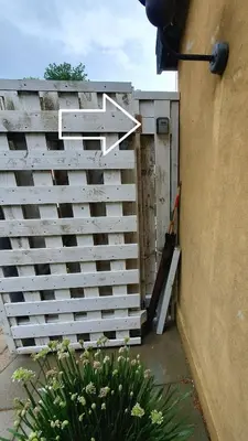 a wooden fence next to a garden with a plant at Airbnb-lejligheder, Villerslev in Villerslev
