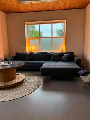 a living room with a couch and a table at Room 5 - Hawkraft kulturhotel in Vestervig