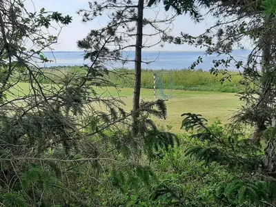 a field with a soccer goal in the middle at 4 person holiday home in Farsø-By Traum in Farsø